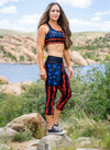 Woman wearing a patriotic set of activewear, capris and sports bra in black red and blue with gun flags of the USA and blue stars out on a hike in arizona by watson lake