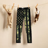 Kids leggings hanging on a clothing wire with toys, from River to Ridge Brand, featuring our camo flag pattern with stars and stripes in camo