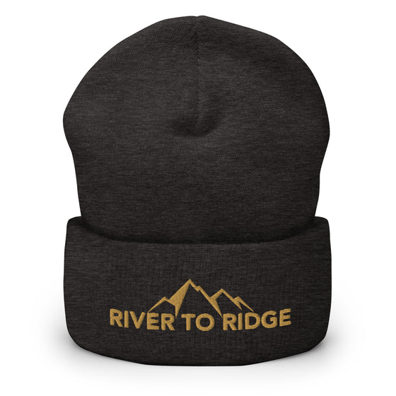 River to Ridge Logo stitched on a beanie. Logo is gold with mountains