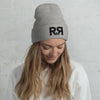 Product mockup of Grey and black River to Ridge logo beanie - worn by a woman looking down