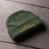 Product mockup of a fisherman's style skull cap beanie from River to Ridge Clothing Brand with the mountain logo on it in green