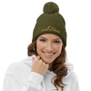 Product mockup of River to Ridge Brand Knit Hat with pom pom worn by a red head woman