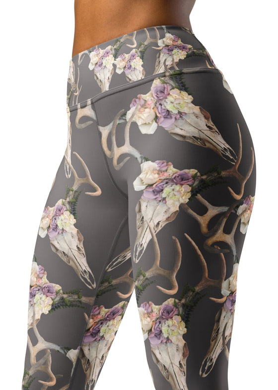 close up of a woman wearing deer antler skull leggings with whitetails on them and flowers