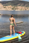 Woman standing on a paddleboard at watson lake in northern arizona wearing an olive high waist bikini with fish on it, athletic