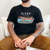 Product mockup of Alaska bush plane Backcountry taxi t shirt from River to Ridge clothing in black worn by a man with tattoos and a drink