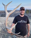 Men's River to Ridge Clothing brand Logo T shirt featuring the mountain logo in black and white worn by a guy holding a big elk antler