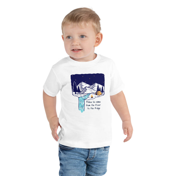 Product mockup of a Christian Scripture T shirt from River To Ridge clothing for children with a waterfall and camping tent on it