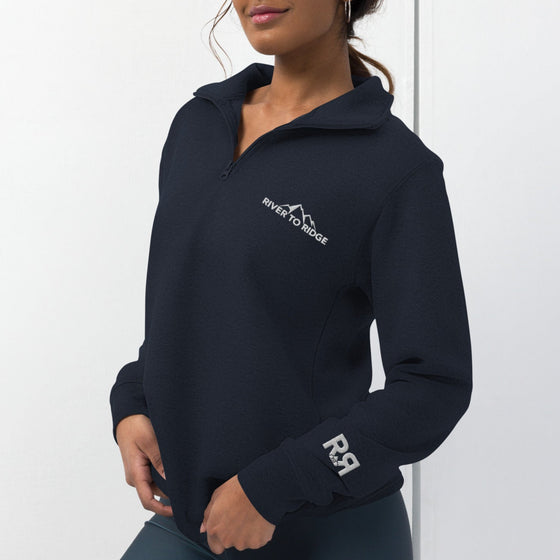 Product mockup of a River to Ridge Brand Fleece Pullover half zip with the embroidery logo on it