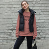 Product mockup of River to Ridge brand deer antler logo long sleeve t shirt in pink on a woman wearing a vest