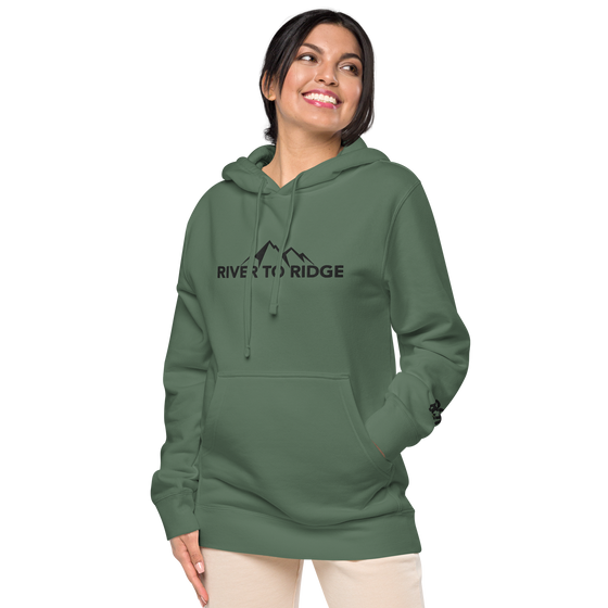 River to Ridge Clothing Brand Womens Vintage Wash Hoodie in green with embroidered logo on chest and sleeve in black worn by a pretty woman