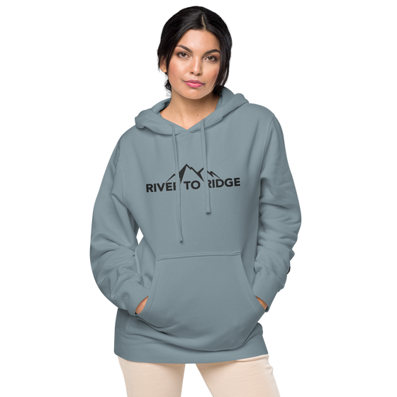 Indigo Blue Womens Hoodie with the River to Ridge Clothing Mountain Logo embroidered on the chest and cuff of sleeve. Worn by a pretty woman