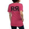 Raspberry colored T Shirt for women with the River to Ridge clothing brand logo on the back, worn by a woman in jeans