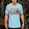 Man wearing a T shirt featuring a Jeep offroad and saying Adventure Is Calling from River to Ridge Clothing Brand at the gym