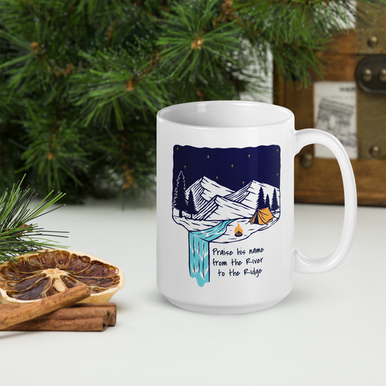 Product mockup of a Christian Outdoor Lifestyle Coffee Mug from River to Ridge Clothing Brand with a mountain scene and tent and uplifting words.