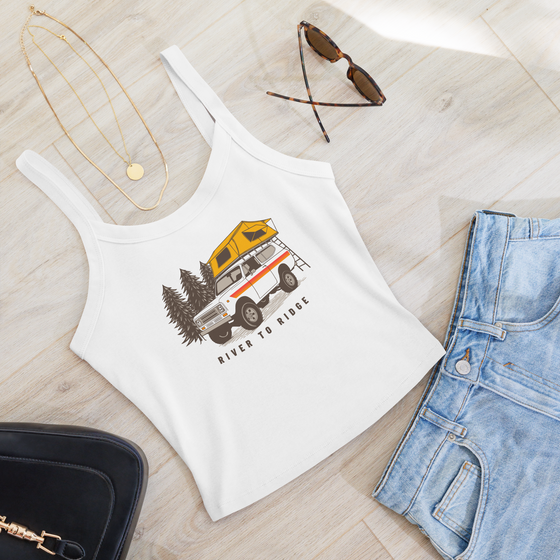 Vintage truck camping logo on a white tank top, International Scout with tent on top for offroading / overlanding adventures and pine trees on a womens top for River to Ridge Clothing Brand