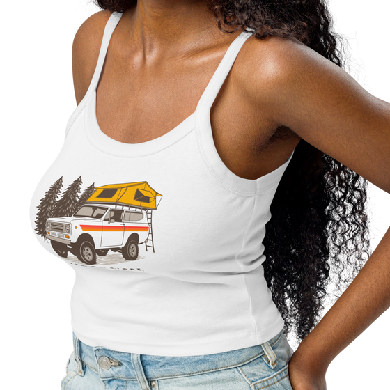 Vintage truck camping logo on a white tank top, International Scout with tent on top for offroading / overlanding adventures and pine trees on a womens top for River to Ridge Clothing Brand