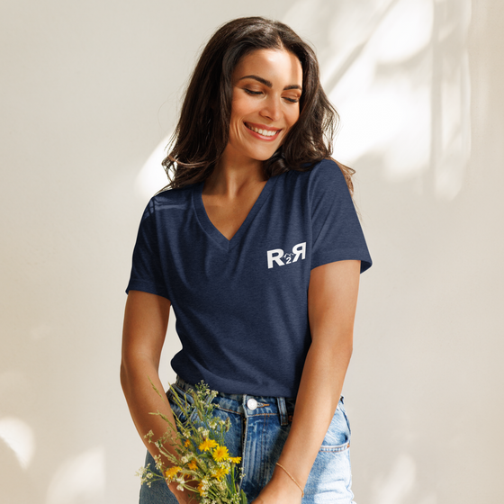 Woman wearing an R2R River to Ridge Clothing Brand V neck T shirt in blue holding flowers